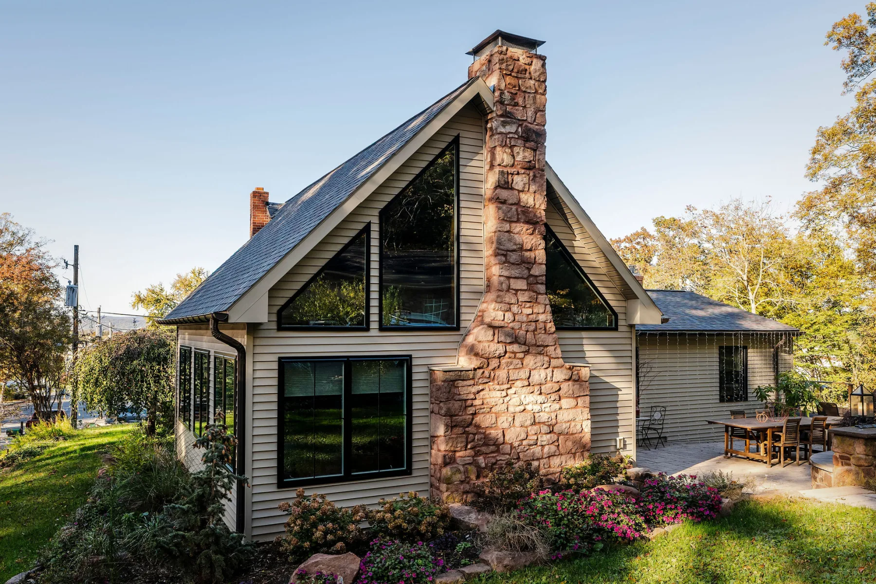 Historic A-frame home addition with stone chimney