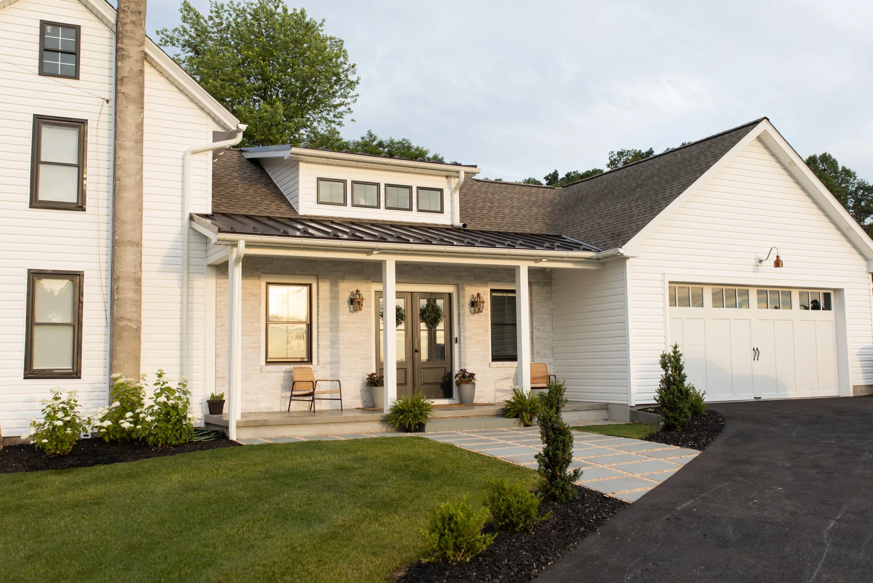 White farmhouse home addition with garage wing