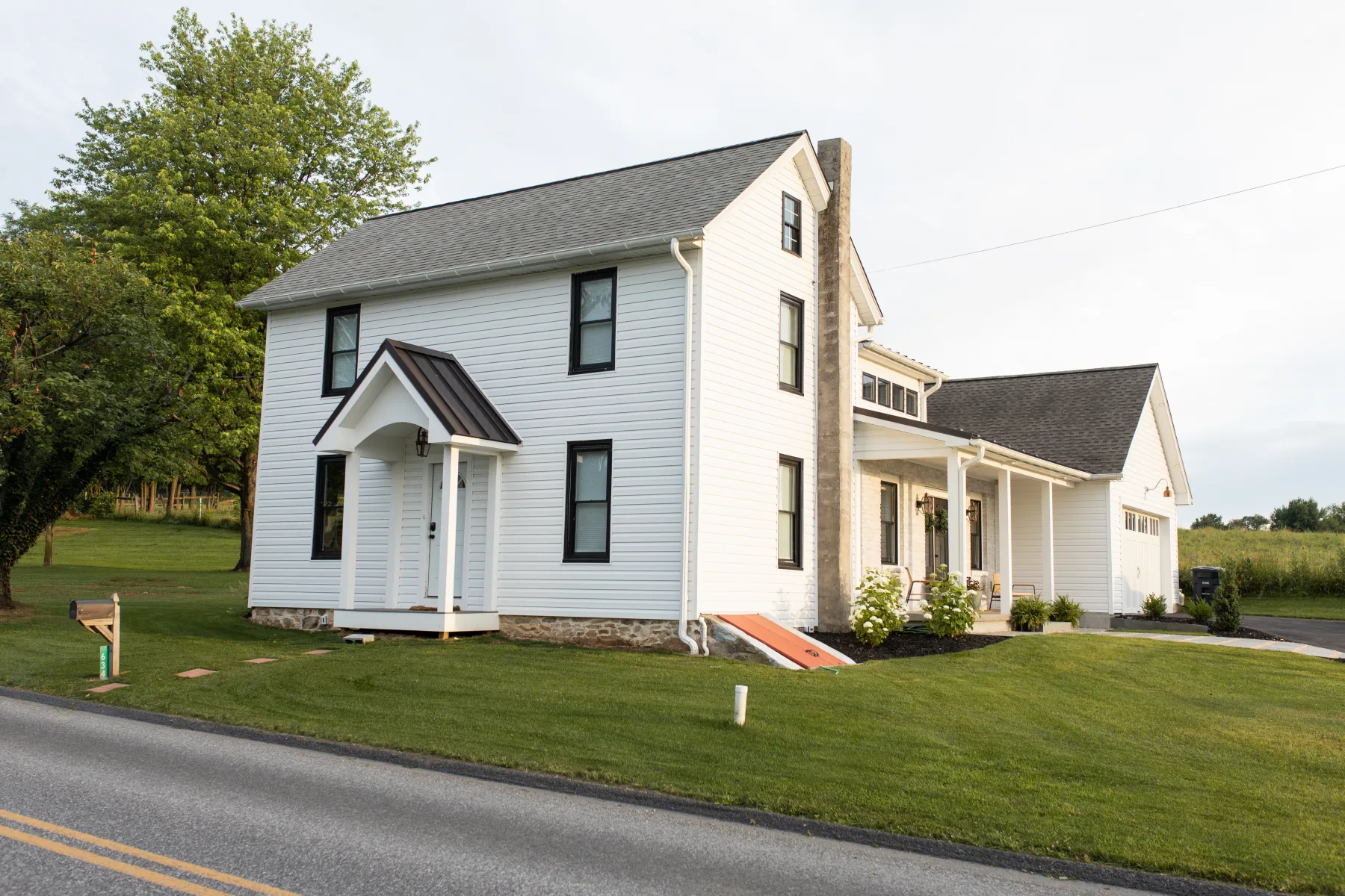 White farmhouse with side wing addition