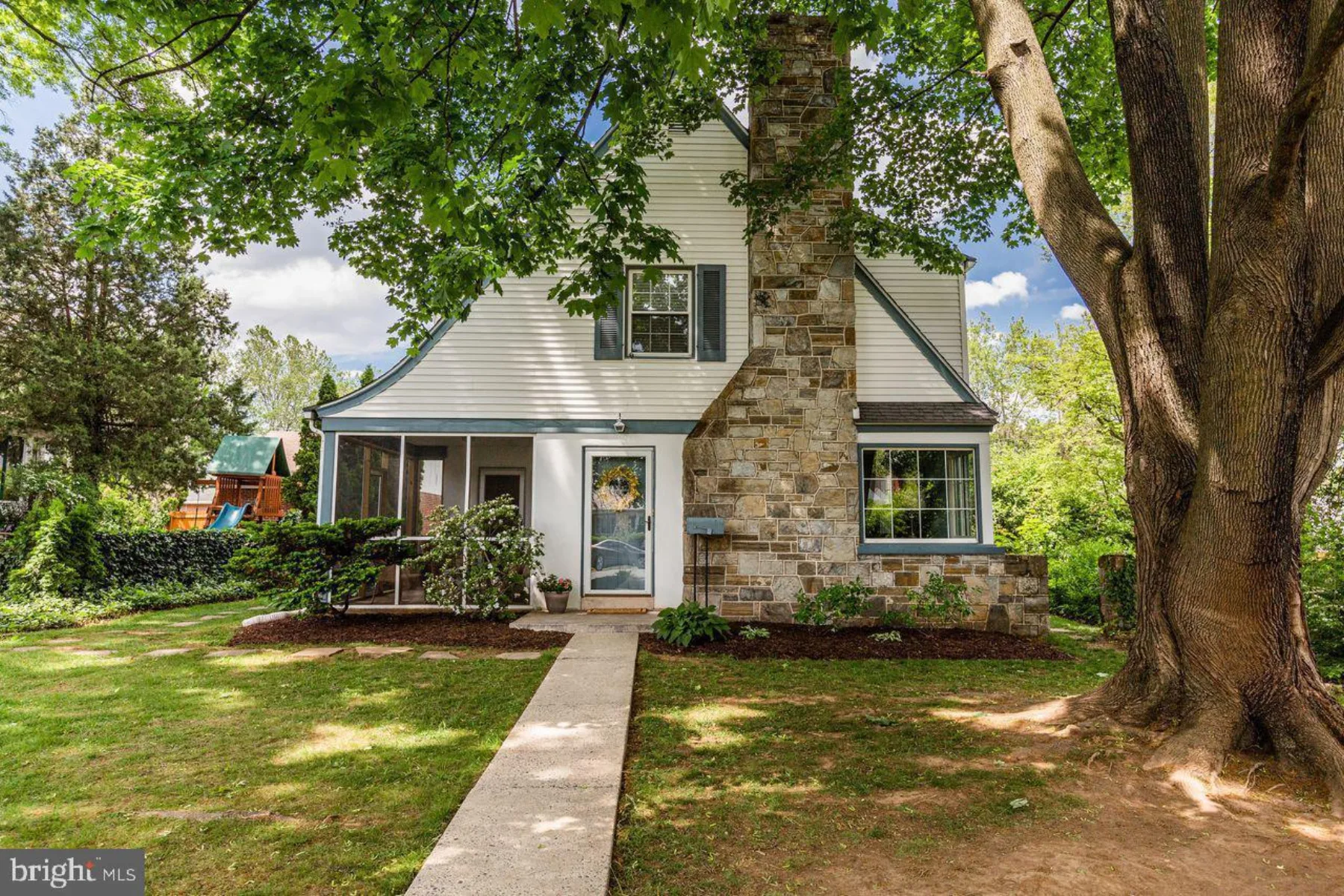 Tudor-style stone home with steep gable
